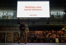 Sydney locked down for another week as Delta variant spreads A man walks under a public health message about social distancing displayed at a shopping plaza in the city center during a lockdown to curb the spread of the COVID-19 outbreak in Sydney, Australia. REUTERS/LOREN ELLIOTT