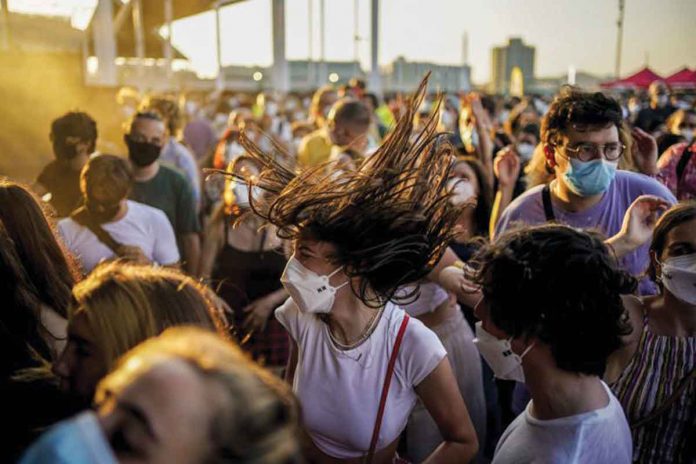 Wearing facemasks, people dance during the Cruilla music festival in Barcelona, Spain. On Wednesday, the country’s top court ruled that the strict pandemic lockdown in 2020 violated the Spanish Constitution .AP/JOAN MATEU