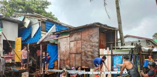 Volunteer groups and personnel of the Bureau of Fire Protection help residents trapped in their homes in Zone 3, Barangay Boulevard, Molo, Iloilo City on July 23, 2021. Torrential rains and a storm surge inundated houses. JAPHET FAJARDO/PN