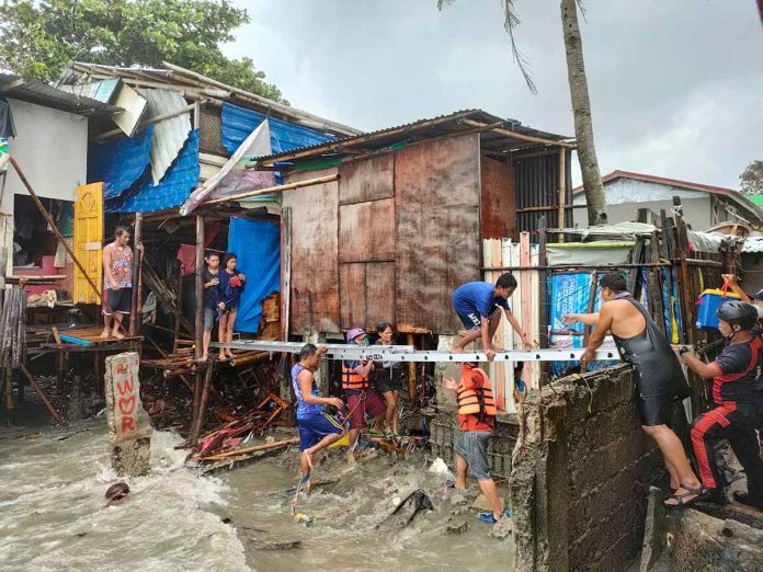 be-on-the-lookout Volunteer groups and personnel of the Bureau of Fire Protection help residents trapped in their homes in Zone 3, Barangay Boulevard, Molo, Iloilo City on July 23, 2021. Torrential rains and a storm surge inundated houses. JAPHET FAJARDO/PN
