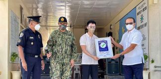Concepcion, Iloilo’s Mayor Raul Banias (rightmost) receives a Safety Seal Award from local government operations officer Janwen Gaspar (second from right) on Monday. Joining them were Concepcion police station chief, Police Major Ronnie Brillo (second from left) and acting Fire Marshall Senior Fire Officer 4 Eulogio Poral Jr. MAYOR RAUL BANIAS/FB