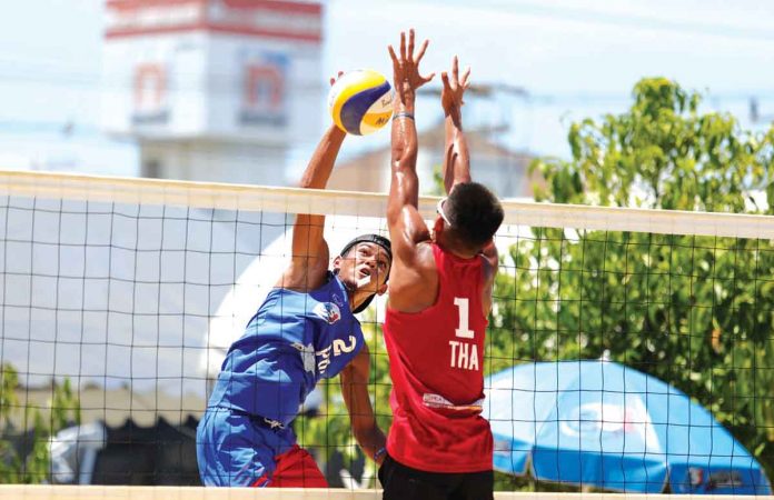 dela-noche-iraya Philippines’ Alexander Iraya (2) attacks the Thai opponent with a spike during the 3rd Asian U19 Beach Volleyball Championships Pool A match on Sunday. AVC