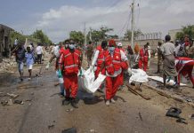 Extremist attack in Somalia kills at least 9 Medical workers carry the body of a civilian who was killed in a suicide car bomb attack that targeted the city's police commissioner in Mogadishu, Somalia. AP PHOTO/FARAH ABDI WARSAMEH