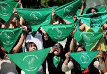 Women hold green handkerchiefs during a protest in support of legal and safe abortion in Mexico City, Mexico. REUTERS/EDGARD GARRIDO