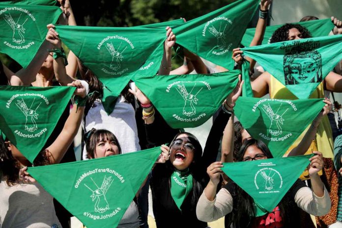 Women hold green handkerchiefs during a protest in support of legal and safe abortion in Mexico City, Mexico. REUTERS/EDGARD GARRIDO