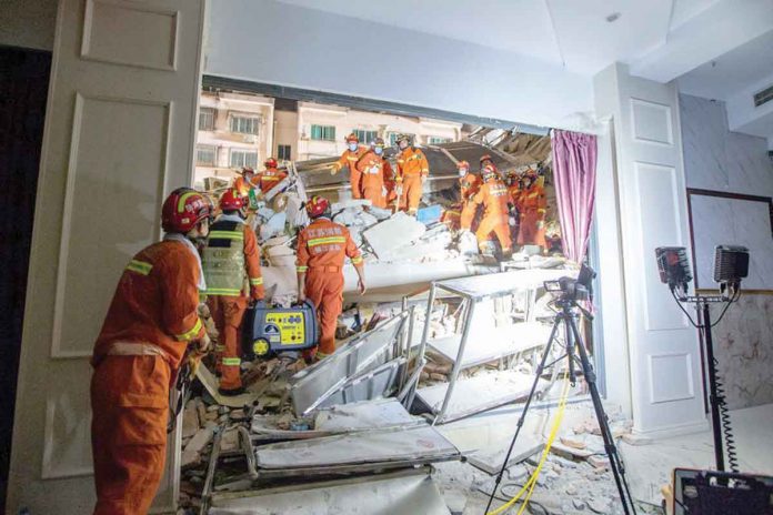 hospital-collapse Rescue workers work at the site where a hotel building collapsed in Suzhou, Jiangsu province, China, on Monday. CHINA DAILY VIA REUTERS