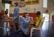 Israel strikes Pfizer deal for new vaccine batch In this file photo, medical personnel test Israeli children for COVID-19 at a testing center in Binyamina, Israel. The country is set to receive a fresh batch of COVID jabs in August. AP PHOTO/ARIEL SCHALIT