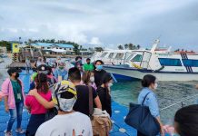 The local government of Malay, Aklan recommends rapid antigen tests for workers returning to Boracay Island to help workplaces there reopen and ensure tourists’ safety. Photo shows people queuing to board a boat bound for Boracay at the jetty port in Caticlan, Malay, Aklan.