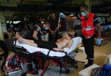 Firefighters and Red Cross health workers attend a man on hunger strike to be transferred to a hospital as he occupies with others a big room of the ULB Francophone University in Brussels, Belgium. AP/FRANCISCO SECO