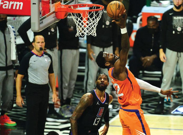 nba Phoenix Suns' DeAndre Ayton (22) goes for a reverse basket against the Los Angeles Clippers in Game 6 of their Western Conference finals. REUTERS