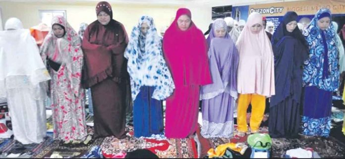 news-holiday Muslim women pray for peace during the celebration of the Eid’l Adha, the Islamic Feast of Sacrifice, at the Quezon City Hall. Similar gatherings were held in Muslim communities in the country. INQUIRER FILE PHOTO/ARNOLD ALMACEN