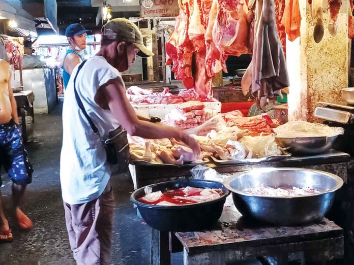 poultry A vendor arranges the dressed chickens he sells in a meat stall in La Paz Public Market in Iloilo City. The country’s agriculture department was recently criticized by a group of chicken farmers for allowing the importation of poultry products.