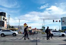 Pedestrians cross the Diversion Road in Iloilo City. From moderate risk last week, the city has been reclassified by the Department of Health as high risk area for coronavirus disease 2019. JAPHET FAJARDO/PN