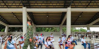 Residents of Barangay Malipayon, Iloilo City wait their turn to avail themselves of the cash aid under the Department of Social Welfare and Development’s Individuals in Crisis Situation program. PANAY NEWS PHOTO