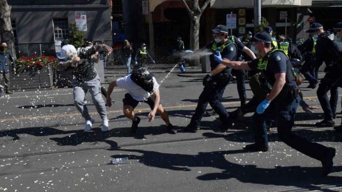 australian-police Police use pepper spray against protesters in Melbourne, Australia. EPA