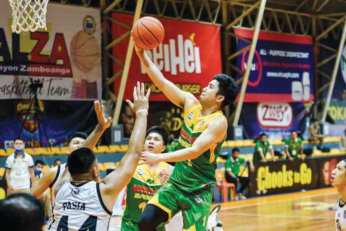 Jumbo Plastic Basilan Peace Riders’ Jonathan Uyloan goes for a layup against the defense of Petra Cement-Roxas Vanguards during Game 2 of the 2021 Chooks-to-Go Pilipinas VisMin Super Cup Mindanao leg finals on Monday at the Pagadian City Gymnasium. The Peace Riders scored 89-70 to notch the crown and take the P500,000 prize. VISMIN SUPER CUP MEDIA BUREAU