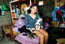 Marriel cradles one of her five cats. PANAY NEWS PHOTO
