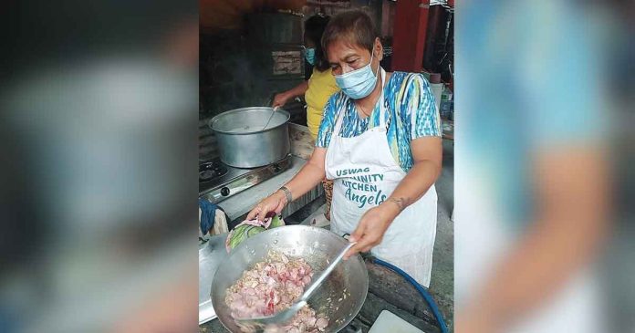 community-kitchen A volunteer prepares food at a community kitchen in Iloilo City amid the metro’s enhanced community quarantine. On July 31, the city served 8,278 economically displaced people families. This was one of the projects Mayor Jerry Treñas highlighted during his State of the City Address over the weekend. DEONALINE DEVELOS EDIS MAGARSE/JERRY TRENAS FB