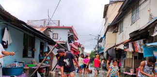 Residents of all ages wade in the floodwaters in Barangay Rizal Pala-pala 2, Iloilo City. All the 180 barangays in this city are susceptible to flooding, according to the Mines and Geosciences Bureau in Region 6. PANAY NEWS PHOTO