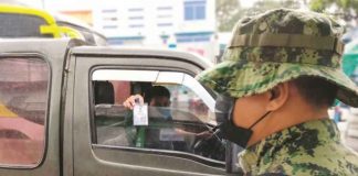 A traveler presents his identification card at a checkpoint in Barangay Tagbak, Jaro, Iloilo City. Police are tightening their monitoring of public mobility as the metro goes into a “hard lockdown”. Only essential travelers are allowed to enter the city. PANAY NEWS PHOTO