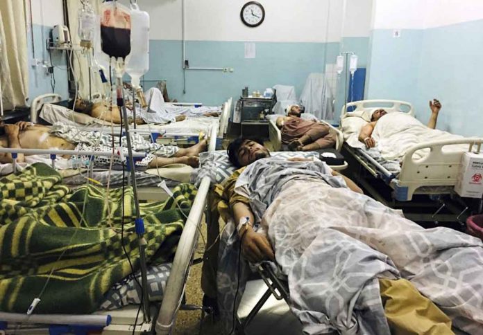 kabul-airport-attack Wounded Afghans lie on a bed at a hospital after a deadly explosion outside the airport in Kabul, Afghanistan, on Thursday. AP/MOHAMMAD ASIF KHAN