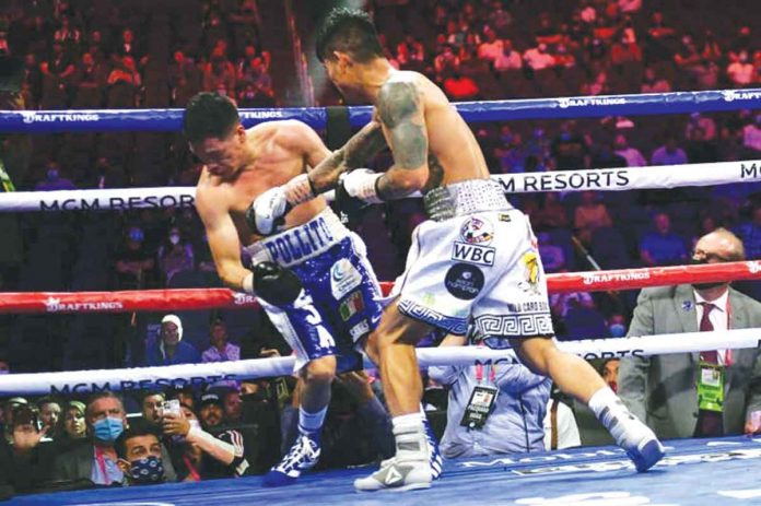 magsayo-cena Mark Magsayo (right) of the Philippines hits Julio Ceja of Mexico with a knockout punch during their WBC featherweight championship bout at the T-Mobile Arena in Las Vegas, Nevada on August 21, 2021. Magsayo knocked out his opponent to improve his boxing record to 23-0-0. AFP