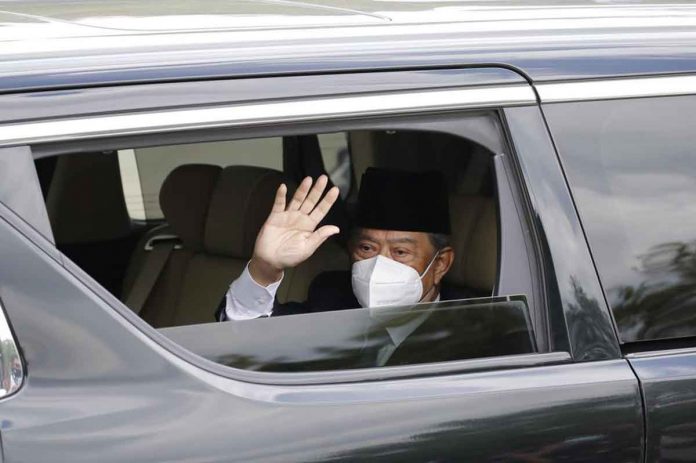 malaysian-pm Embattled Malaysian Prime Minister Muhyiddin Yassin waves from a car while entering the National Palace to meet with the King, Sultan Abdullah Ahmad Shah, in Kuala Lumpur, Malaysia on Monday. AP/FL WONG