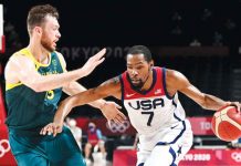Team USA’s Kevin Durant (7) drives past the defense of Australia Boomers’ Nic Kay during the 2020 Tokyo Olympics men’s basketball semifinals on Thursday at the Saitama Super Arena in Tokyo, Japan. The USA mauled Australia, 97-78, to book a slot in the gold medal bout against France. GETTY IMAGES