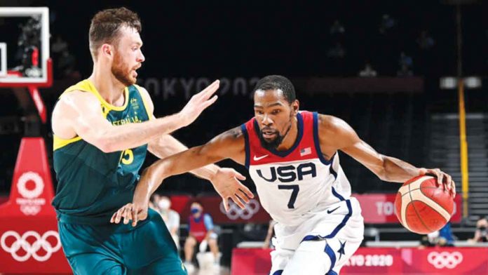 olympic-bball Team USA’s Kevin Durant (7) drives past the defense of Australia Boomers’ Nic Kay during the 2020 Tokyo Olympics men’s basketball semifinals on Thursday at the Saitama Super Arena in Tokyo, Japan. The USA mauled Australia, 97-78, to book a slot in the gold medal bout against France. GETTY IMAGES