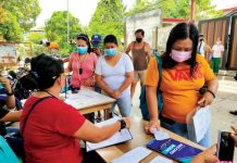 Non-residents off-limits to Oton town Residents secure quarantine passes at the barangay hall of Poblacion West, Oton, Iloilo. Travel is restricted to essentials amid surging coronavirus disease 2019 cases in the town. Oton had 300 active COVID-19 cases as of Aug. 17. PANAY NEWS PHOTO