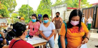 Residents secure quarantine passes at the barangay hall of Poblacion West, Oton, Iloilo. Travel is restricted to essentials amid surging coronavirus disease 2019 cases in the town. Oton had 300 active COVID-19 cases as of Aug. 17. PANAY NEWS PHOTO