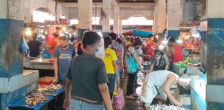 People wear facemask and face shield at the public market of Kalibo, Aklan. The coronavirus risk level classification of Aklan has been downgraded to moderate risk.