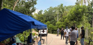 Barangay officials guard the entrance to Barangay Salvacion, Nueva Valencia, Guimaaas. The village is on an extended lockdown due to coronavirus disease.