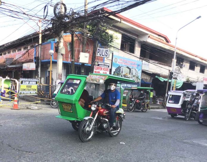 Due to the rise in coronavirus infections, Aklan has been placed under modified enhanced community quarantine from Aug. 1 to 15, 2-21. Photo shows a tricycle driver in Kalibo, Aklan wearing a facemask while working.