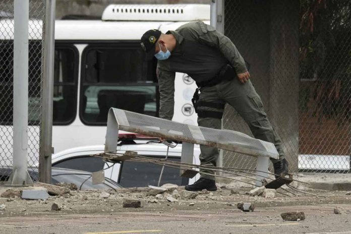 colombia-w-1 A police officer inspects damage at a police station after a bomb exploded in Cucuta, Colombia, on Monday. AP/FERLEY OSPINA