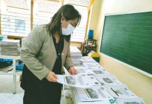 Dr. Ma. Luz Delos Reyes, schools division superintendent of Iloilo City, checks learning materials in Jaro 1 Elementary School in Jaro district. PANAY NEWS PHOTO