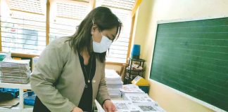 Dr. Ma. Luz Delos Reyes, schools division superintendent of Iloilo City, checks learning materials in Jaro 1 Elementary School in Jaro district. PANAY NEWS PHOTO