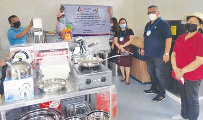 Representatives of the Pangabu-an Kabuhayan Food Processing Association receive the equipment for the meat and boneless bangus processing project, which is expected to provide additional income to the farmers in Jamindan, Capiz. DOLE