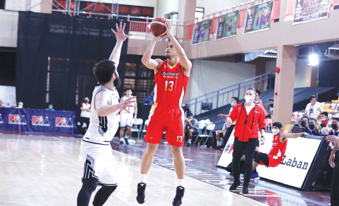 northport Garvo Lanete of NorthPort Batang Pier (13) attempts to score over the outstretched arms of Andre Paras of Blackwater Bossing during Thursday's PBA Philippine Cup match. Batang Pier made a triumphant return after a 98-73 victory against the Bossing. PBA