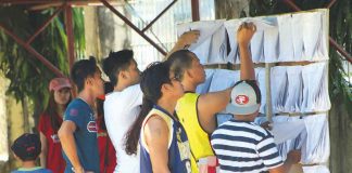 People in Kalibo, Aklan check if their names are in the Commission on Elections’ official list of registered voters, in this file photo. FILE PHOTO