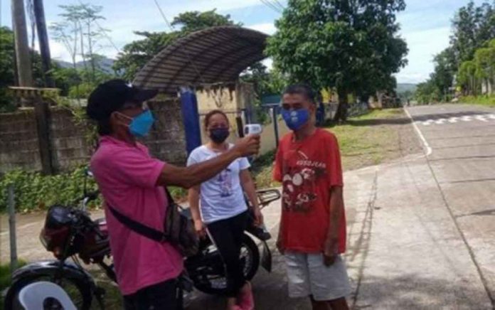 region-antique-border A barangay official in Idio, Sebaste town checks the body temperature of a resident in their barangay border control in this undated photo. PHOTO COURTESY OF ANTIQUE LNB