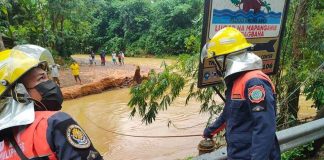 Personnel of the Bureau of Fire Protection in Malay, Aklan double as disaster rescue workers. They are shown here monitoring the water level of a river. PHOTO MALAY BFP