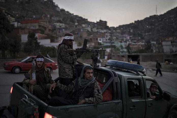 taliban Taliban fighters sit on the back of a pickup truck as they stop on a hillside in Kabul, Afghanistan. The Taliban expanded their interim Cabinet by naming deputy ministers on Tuesday but failed to appoint any women. AP