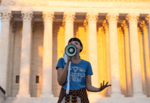 Texas abortion clinics will be protected, Justice Department says An activist protests against the new Texas abortion law outside the Supreme Court in Washington DC. GETTY IMAGES