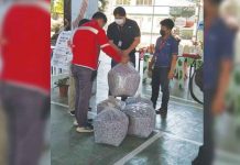 URC extends support to CDO LGU’s waste management project URC-ESMO, led by URC VisMin Cluster head Michael Estacio (center), turns over five bags of shredded plastics during the turnover event held at the Department of Environment and Natural Resources Compound in Cagayan de Oro City.