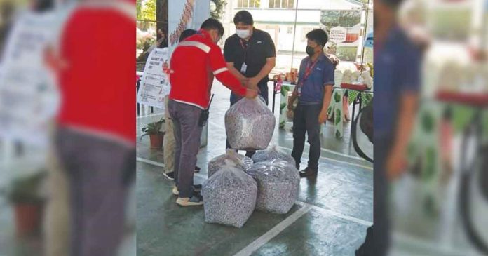 urc URC-ESMO, led by URC VisMin Cluster head Michael Estacio (center), turns over five bags of shredded plastics during the turnover event held at the Department of Environment and Natural Resources Compound in Cagayan de Oro City.