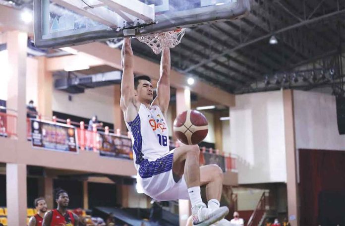 TNT TNT Tropang Giga’s Jeth Troy Rosario hangs into the ring after a two-handed dunk in the fourth quarter. PBA MEDIA BUREAU
