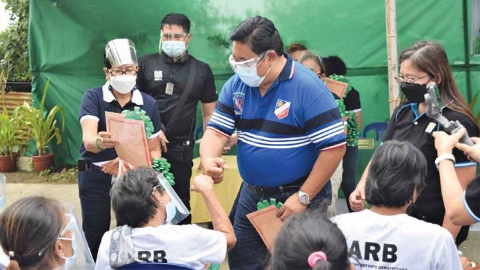banner-1 Department of Agrarian Reform Secretary, Atty. Bro. John R. Castriciones administers the distribution of Certificates of Land Ownership Award.