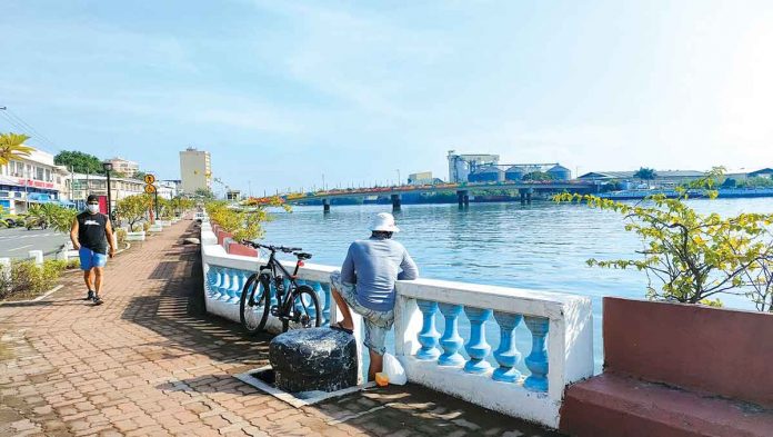 iloilo-city Iloilo City hopes to open more businesses to revitalize the economy when its coronavirus quarantine classification is downgraded to general community quarantine or lower. Coronavirus cases in the metropolis are declining, and more Ilonggos are getting vaccinated. Photo shows residents enjoying the picturesque view of the Iloilo River. PANAY NEWS PHOTO