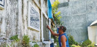 The people of San Jose, Antique are being enjoined to start cleaning the tombs of their dead loved ones prior to the scheduled visiting days (Oct. 25 to 28). Photo shows a man cleaning a tomb at the San Jose Catholic Cemetery. PHOTOS BY JAP FAJARDO
